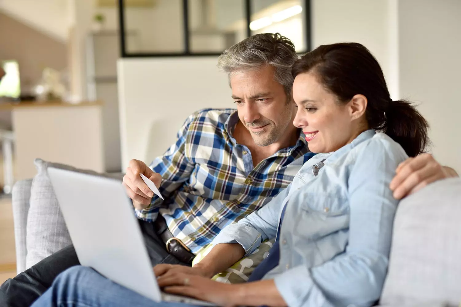Older couple sitting with laptop