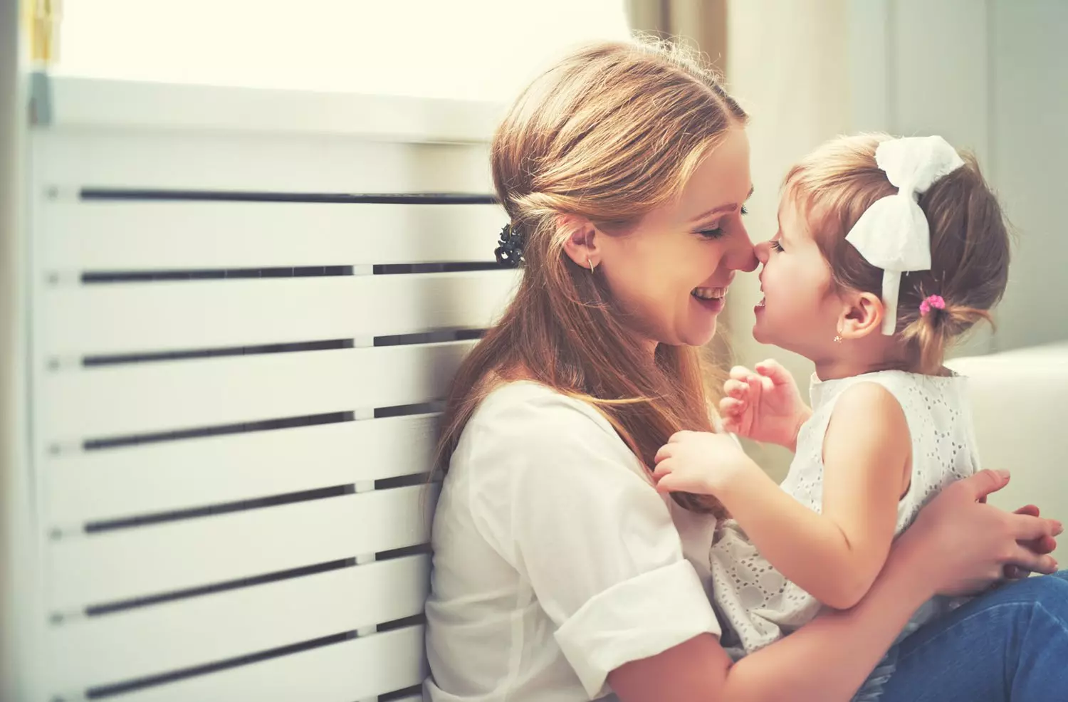 Mother hugging young daughter