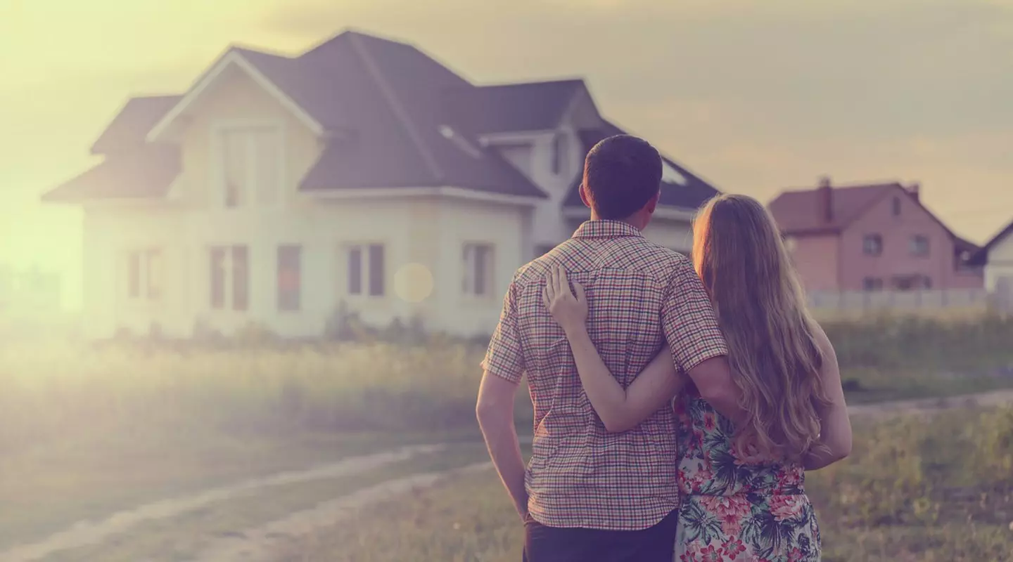 Couple facing towards their new house