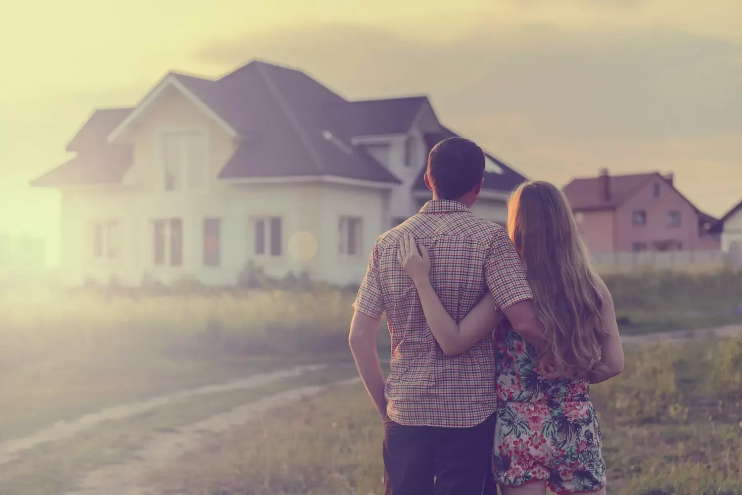 Couple facing towards their new house