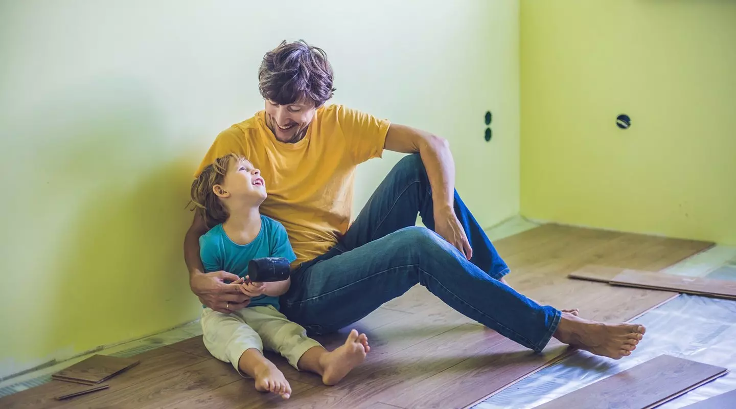 Father and son working on house
