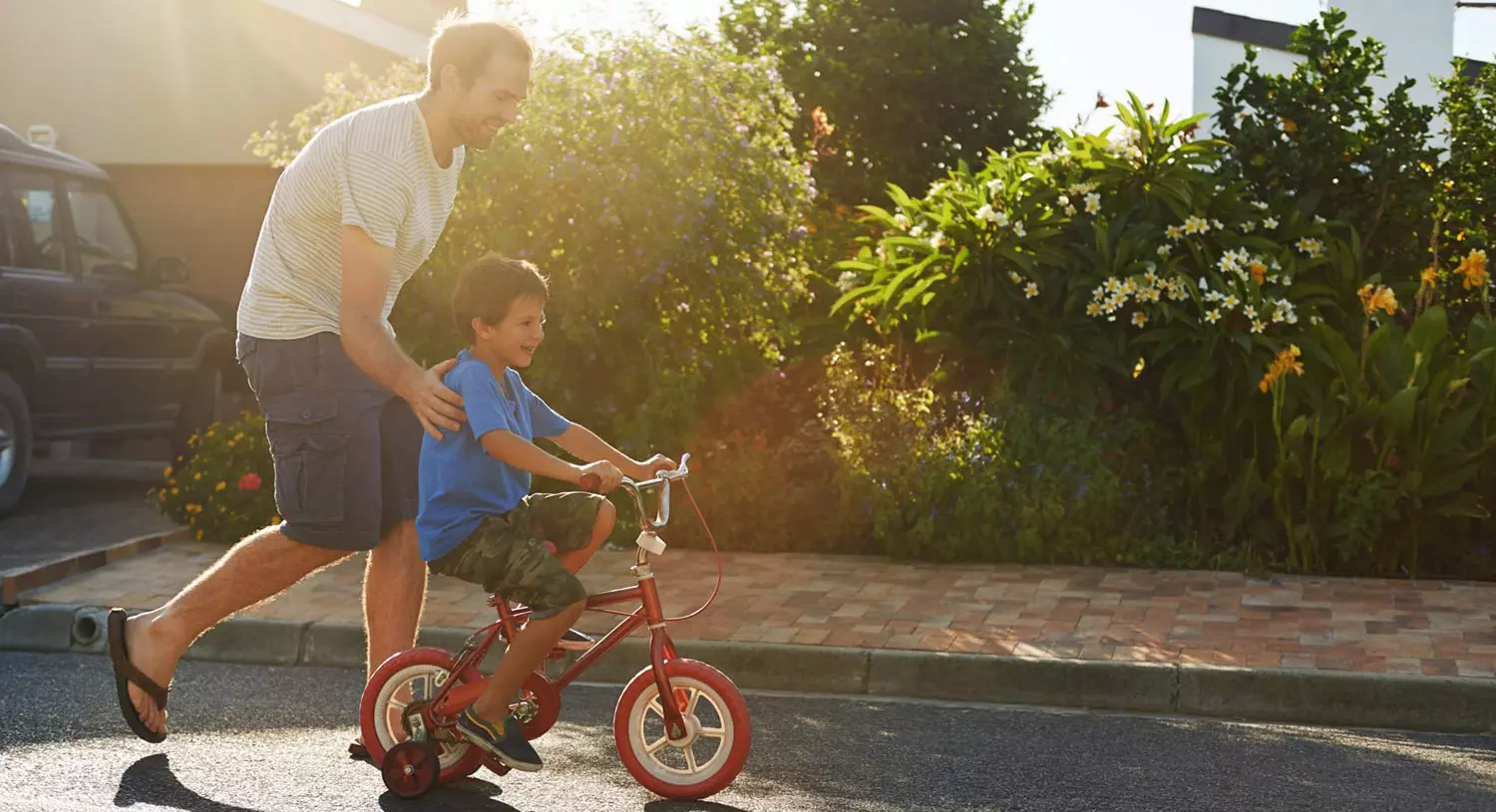 Father helping his son ride a bike