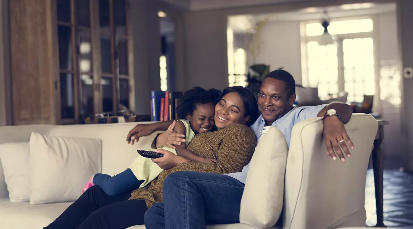 Family sitting watching tv