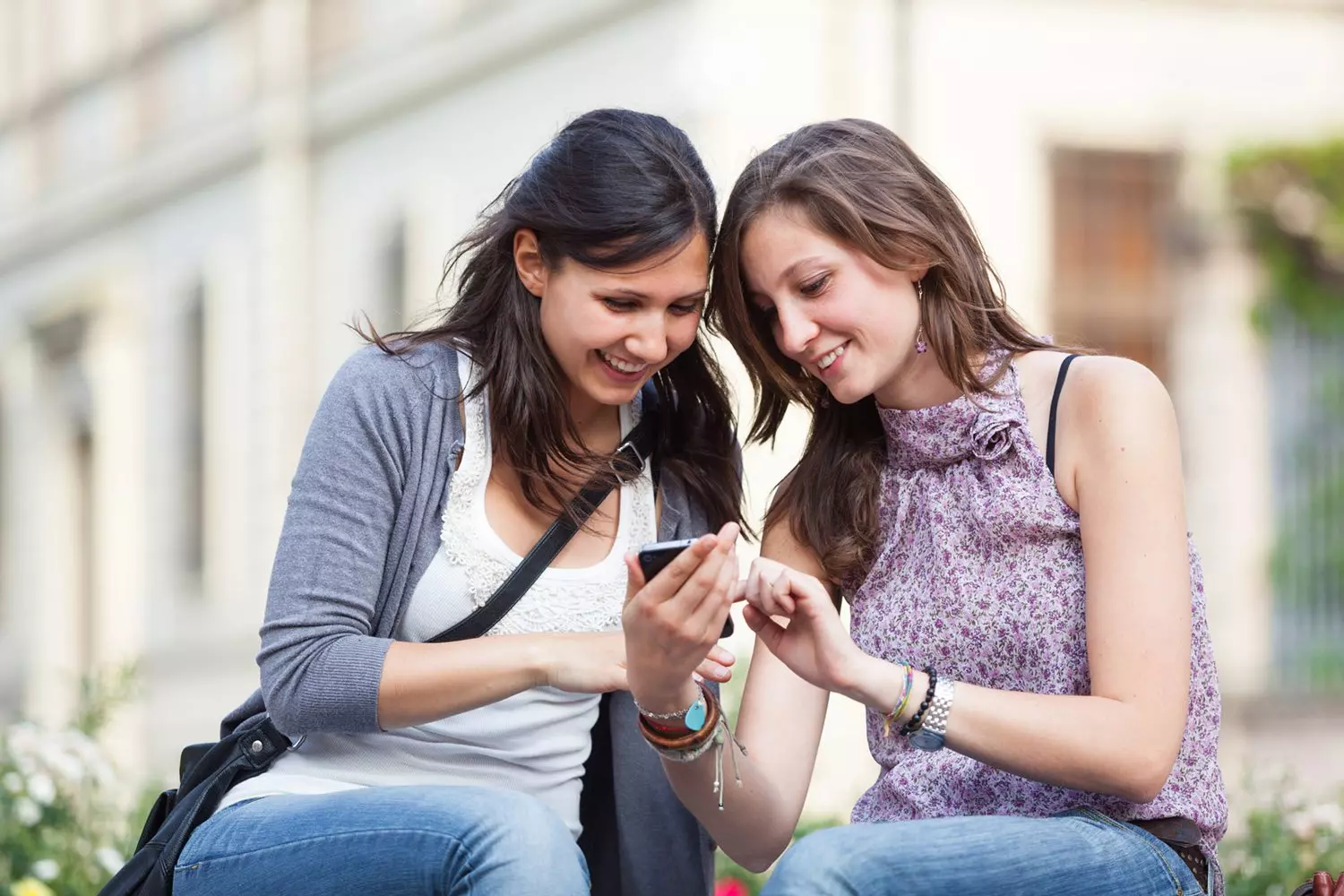 Two girls looking at their phone