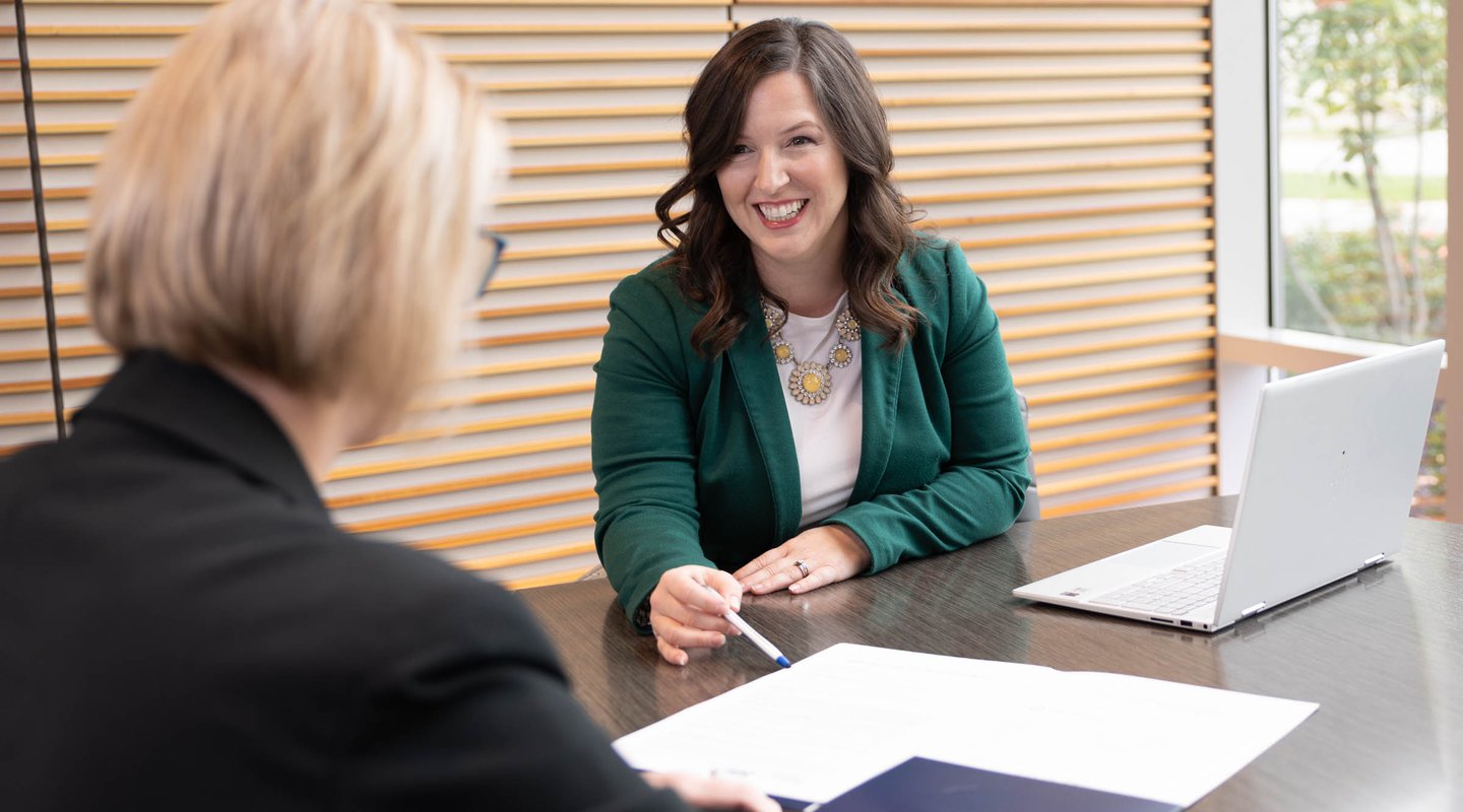 customer and bank employee discussing checking accounts