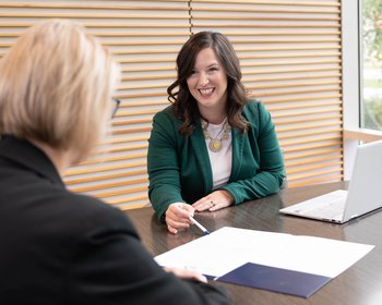 customer and bank employee discussing checking accounts
