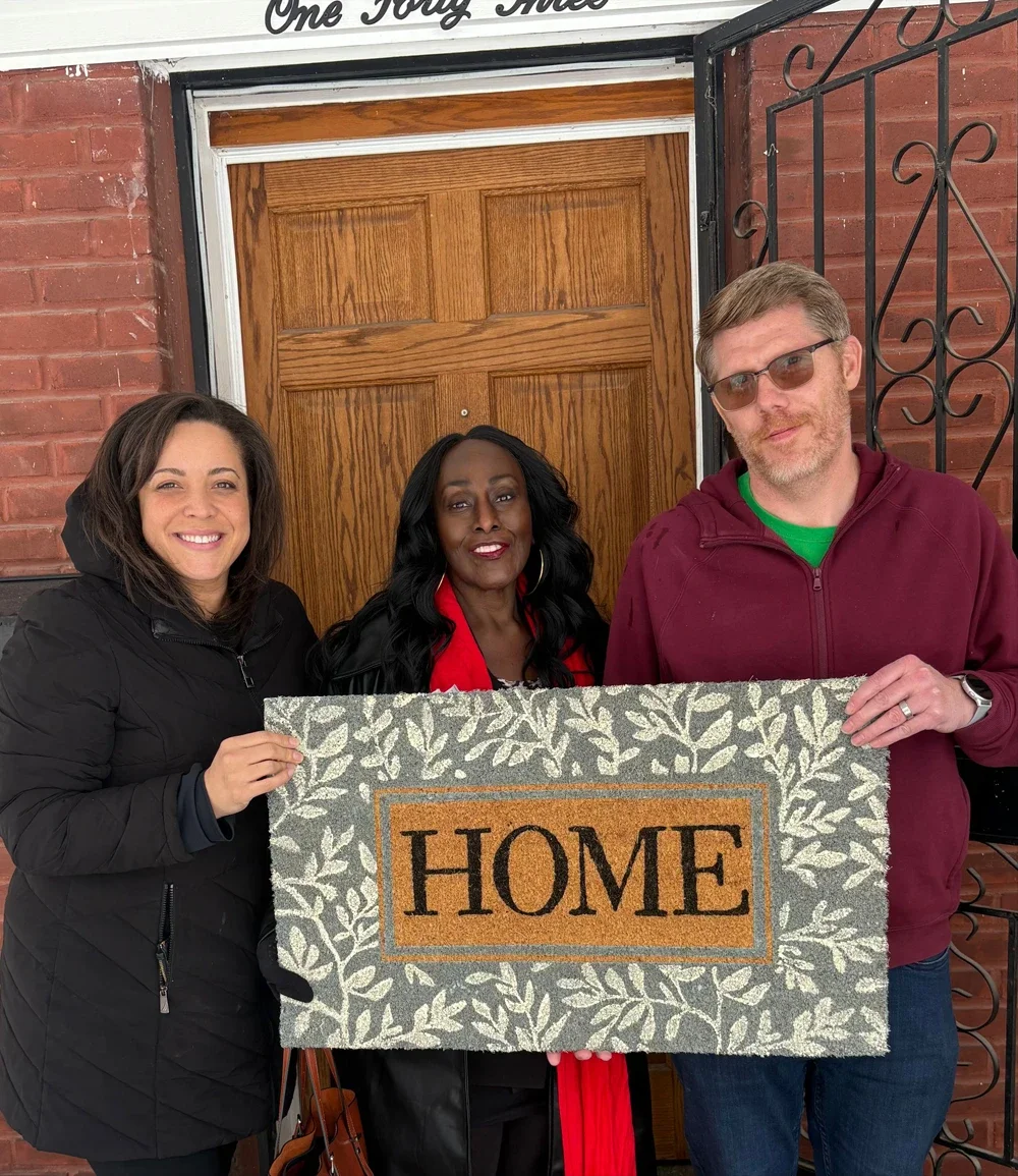 homebuyers with welcome mat