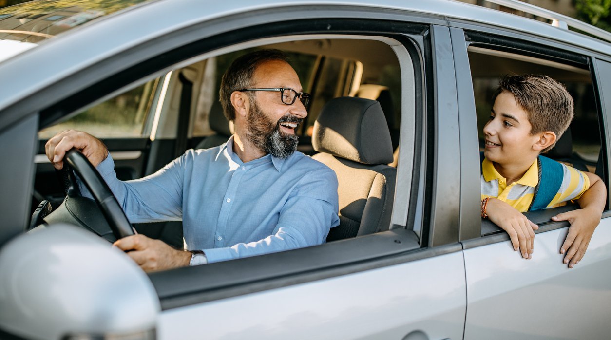 happy dad and child in a car