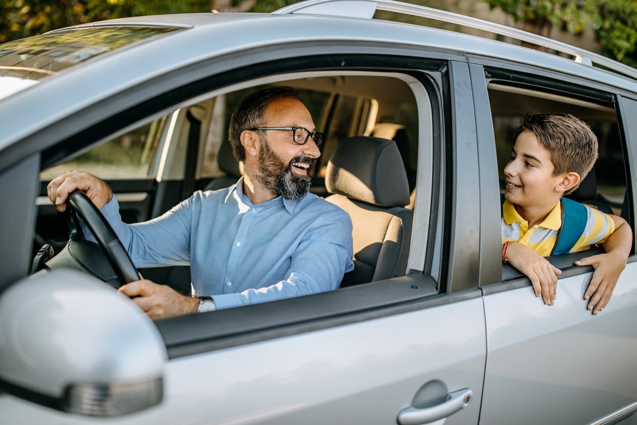 happy dad and child in a car