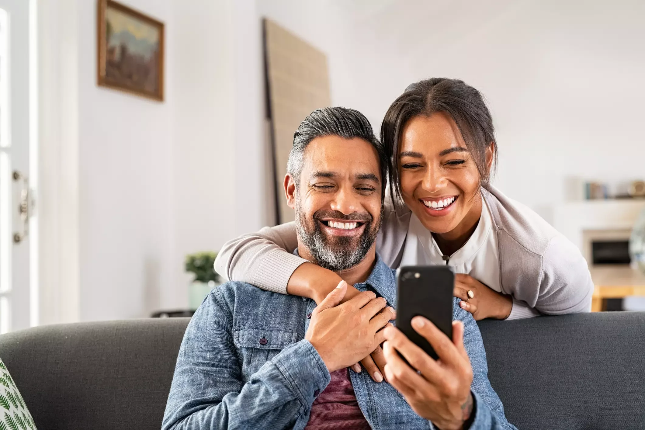 smiling couple looking at phone