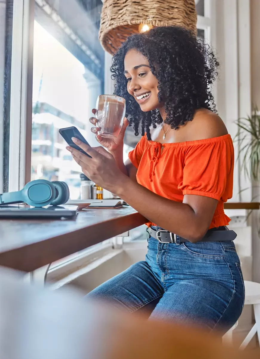 Woman in coffee shop looking at phone