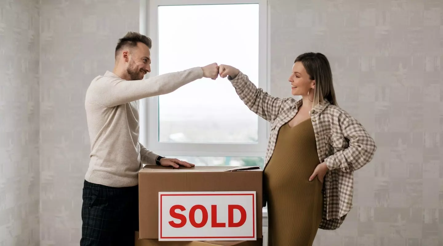 couple fist bumping over moving box