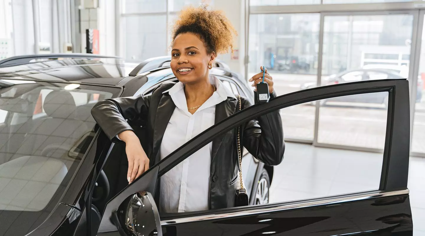 woman buying car at dealership