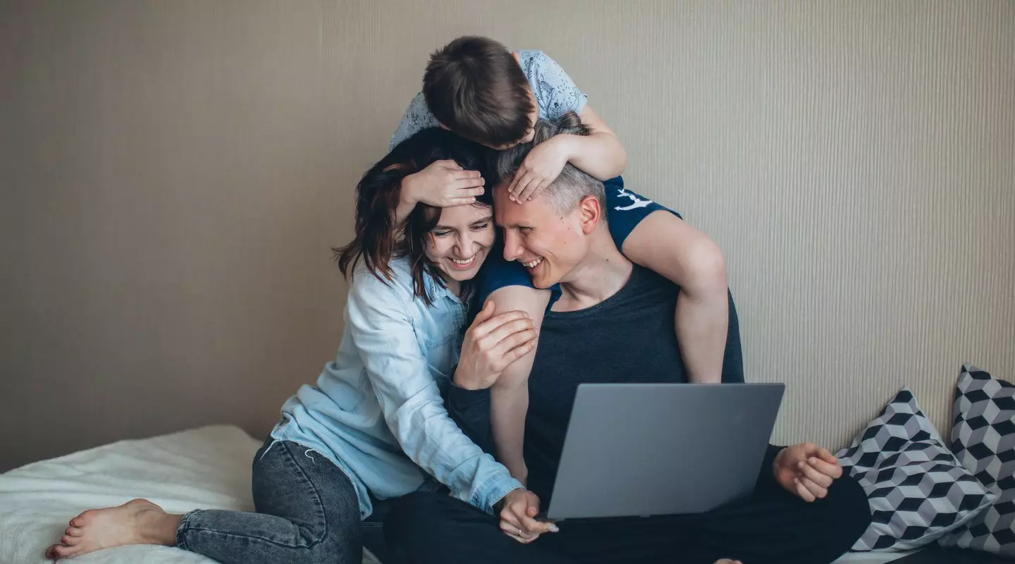 family laughing with computer