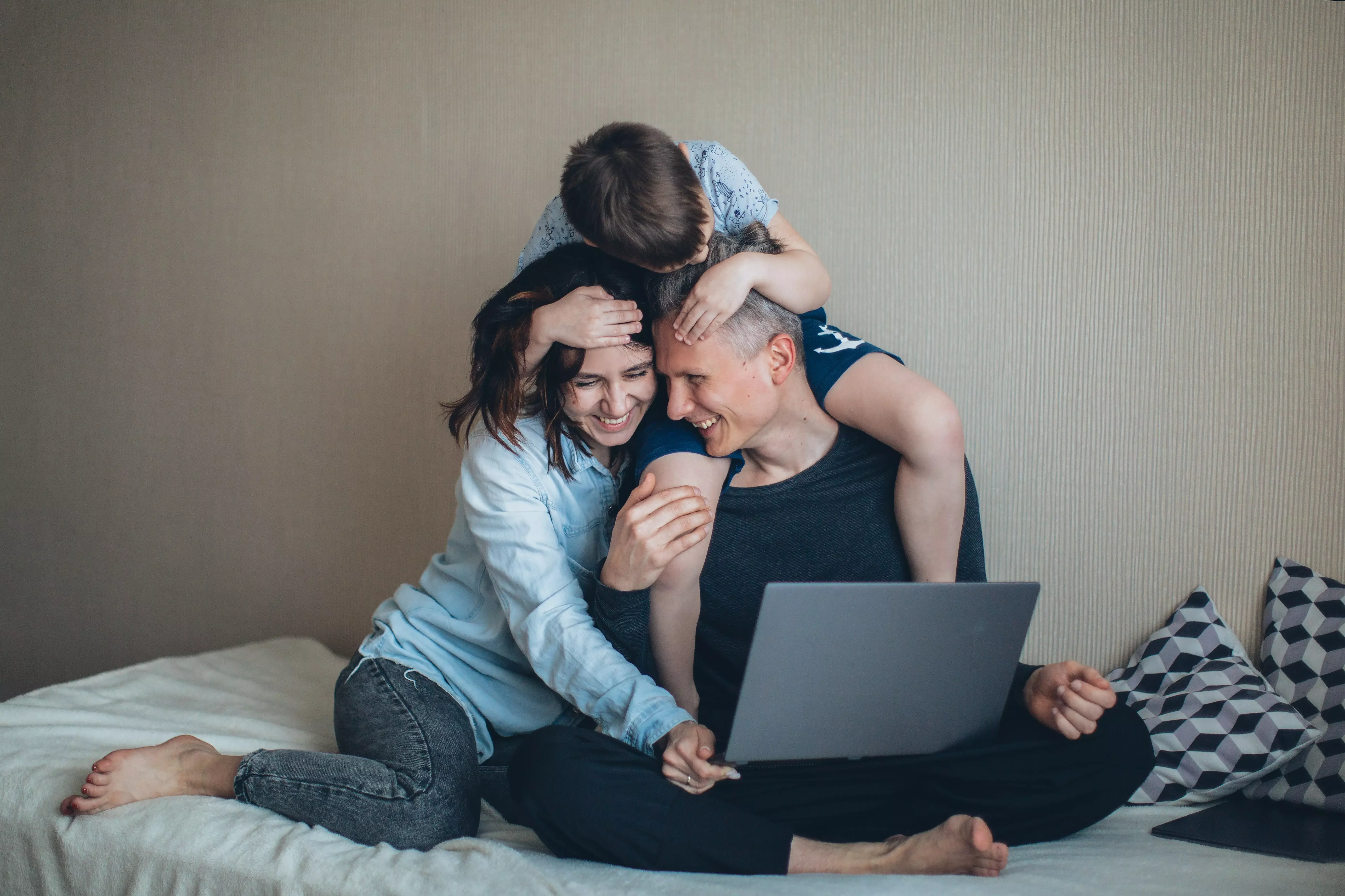family laughing with computer