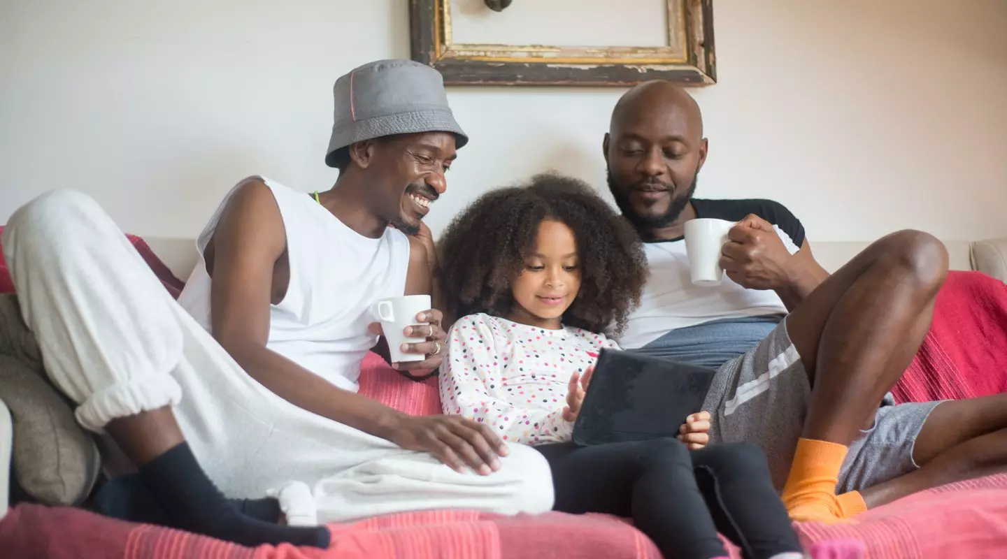 two african american men teaching a child