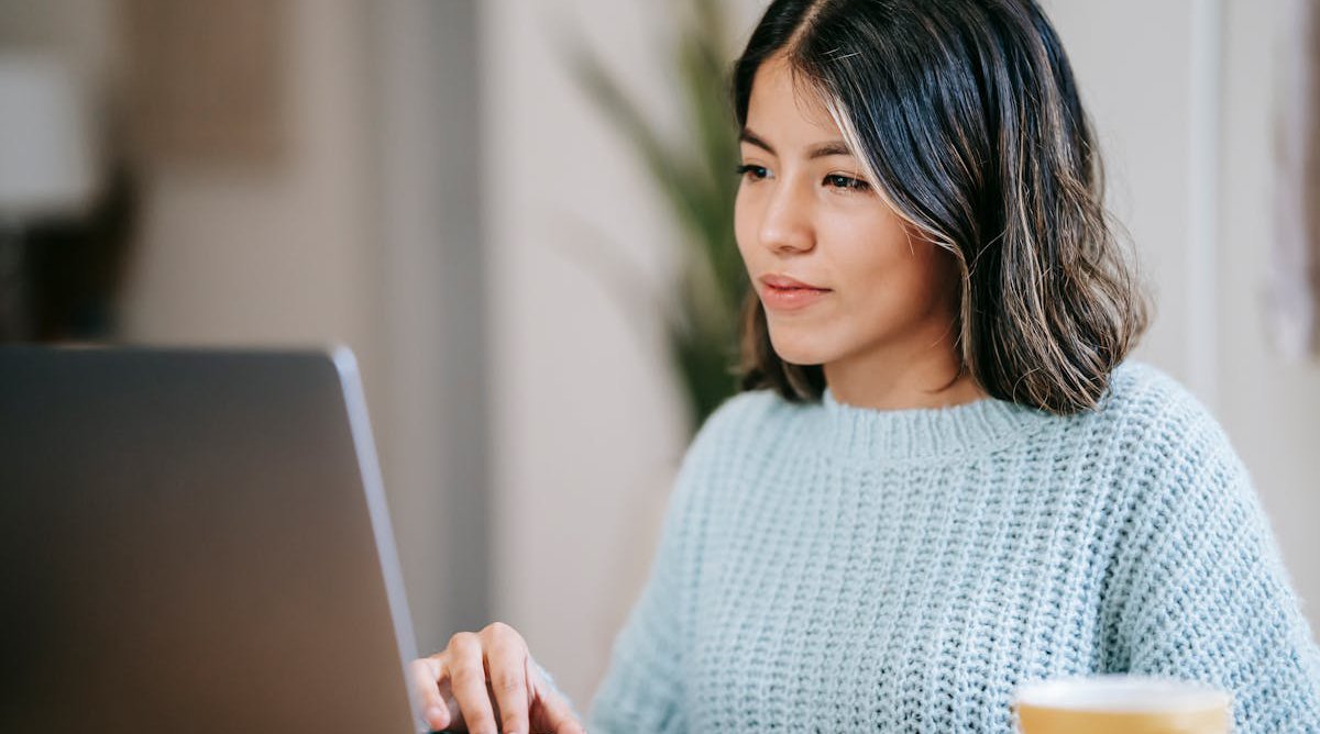 woman typing on laptop