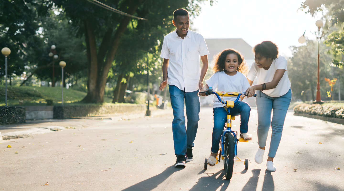 family with child on bike