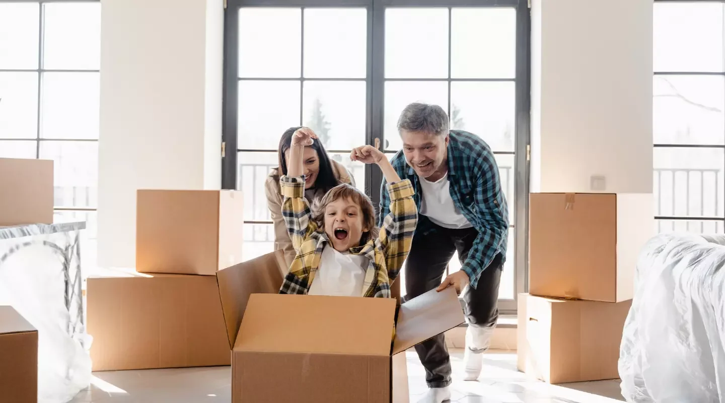 couple sliding child in moving box